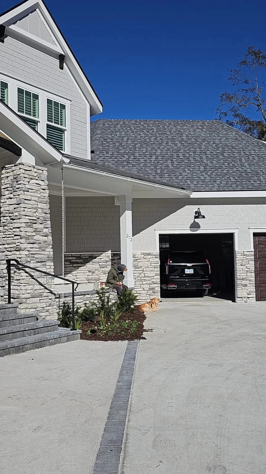 Completed white seamless gutters along a Beaufort, South Carolina driveway